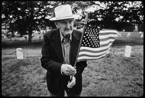Man Holding Flag, a photograph by Brian Lanker